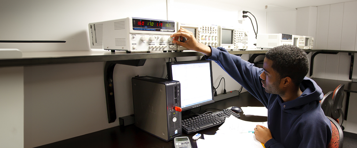 A student works on computer equipment in a New York Tech computer lab.