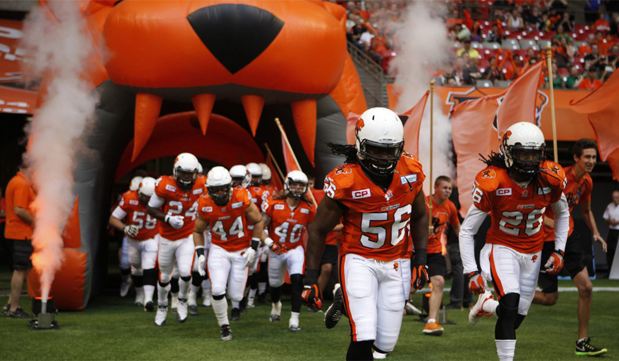 Football players coming onto the field