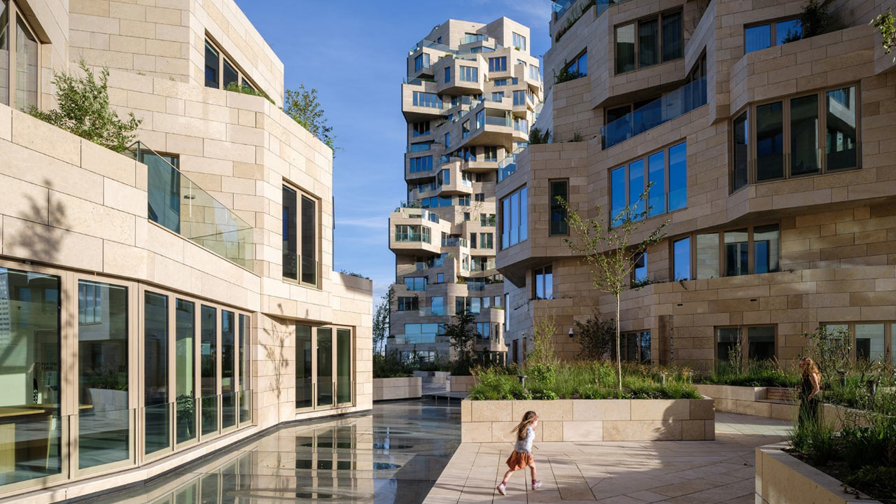 modern architecture with a water way and park between buildings. A mother and child walk around the park.