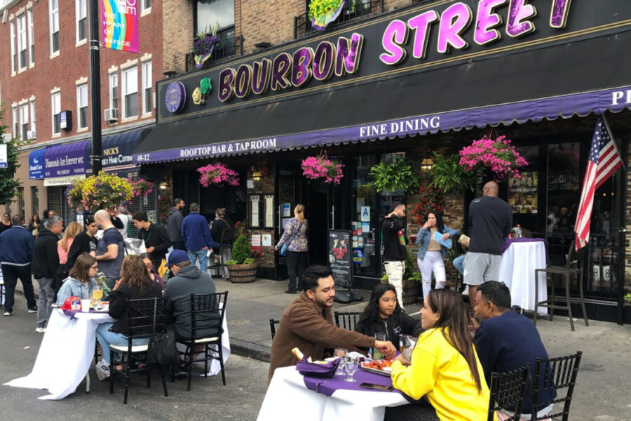 Groups of people sitting outside the Bourbon Street Restaurant.