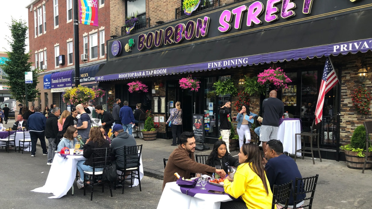 Groups of people sitting outside the Bourbon Street Restaurant.