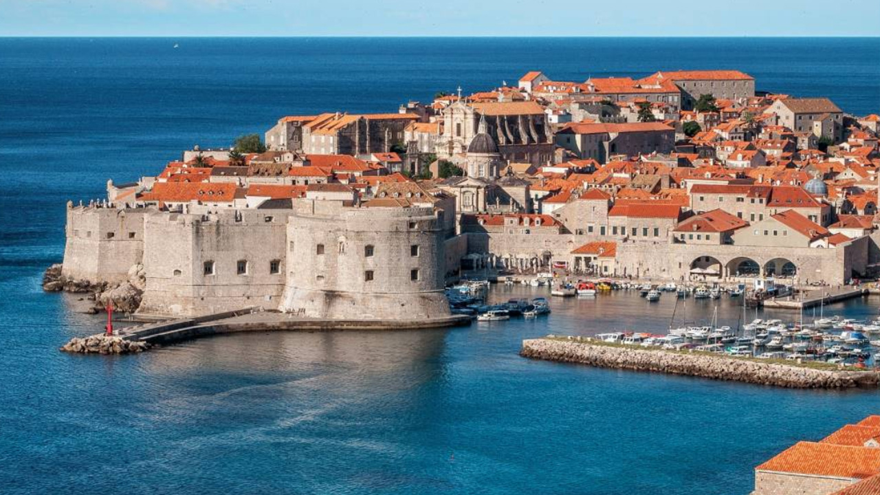 View of a castle on a bright blue coast.