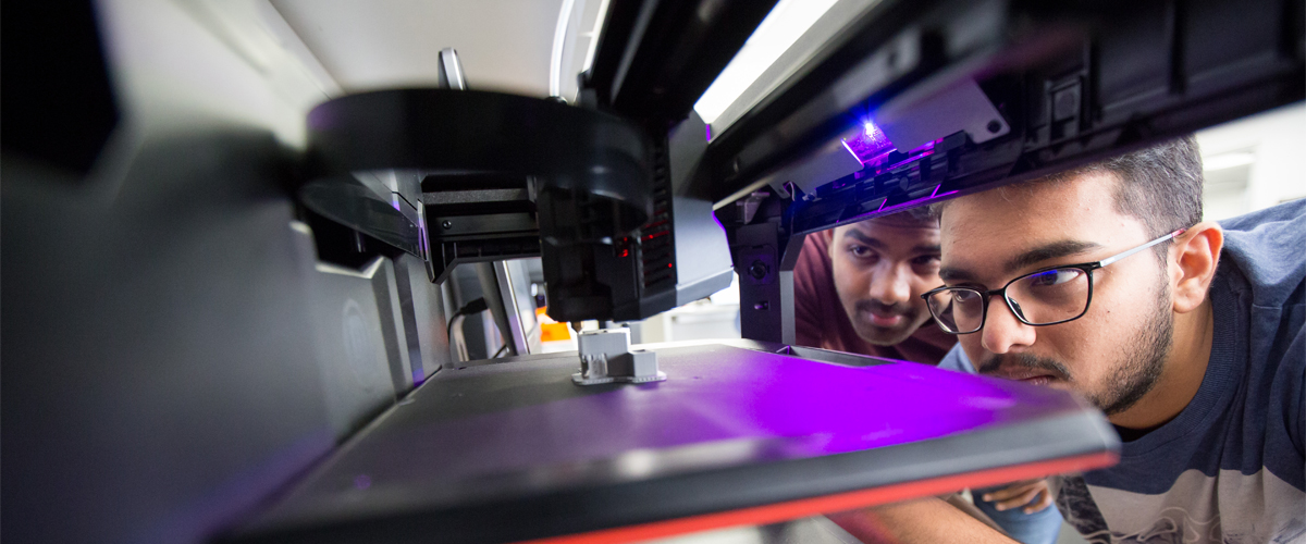 A student works with a 3-D printer.