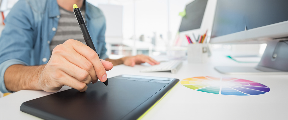 A student prepares for graphic design work using a stylus.