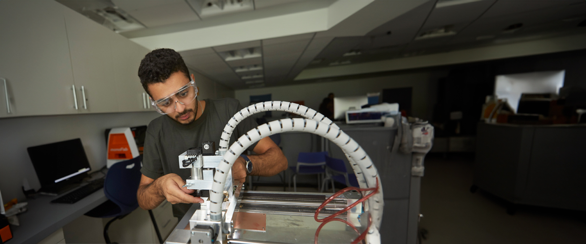 A student works on a bioengineering project in a lab.