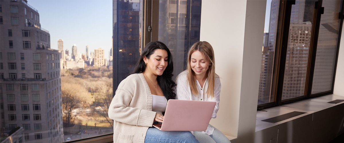 Two students studying with one laptop on the New York Tech Manhattan campus.