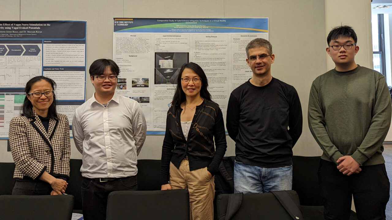 A group of five students standing front of their project boards.