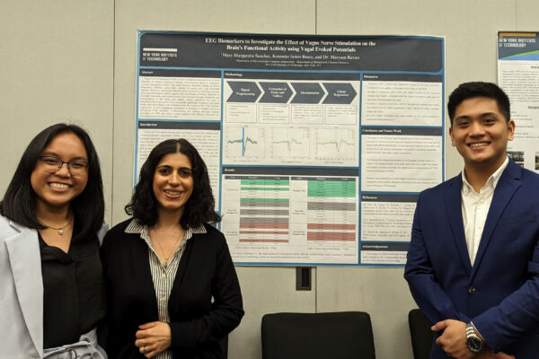 Three student standing in front of their project board.