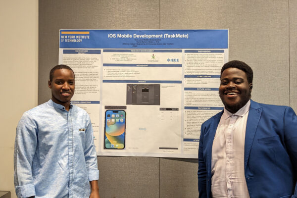 Two student standing in front of their project board.