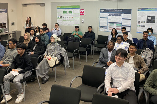 A classroom full of students with project boards around them.