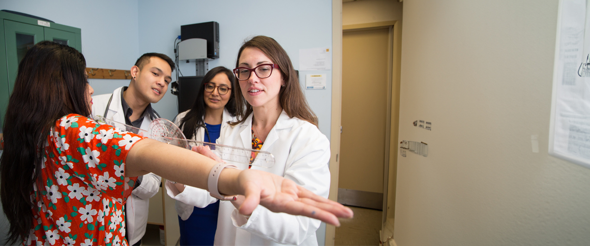 Occupational therapy students observe treatment on a client.