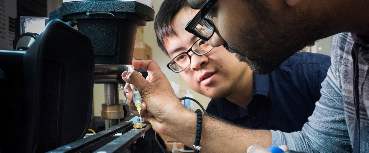 Two students are working on an engineering project.