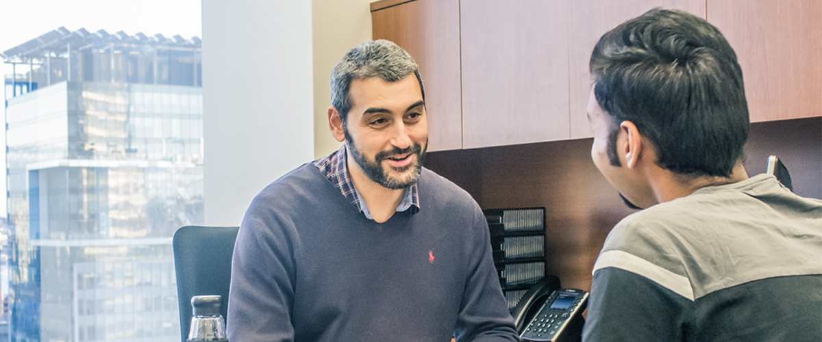 A student is meeting with a mentor in an office.