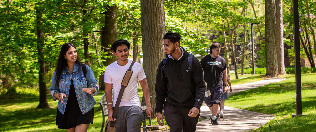 Three students walking on the Long Island campus