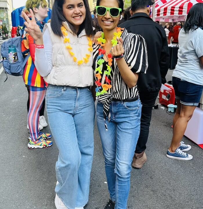 Two students smiling and posing for the camera.