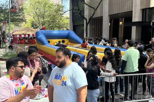 Line of students around a bouncy obstacle course