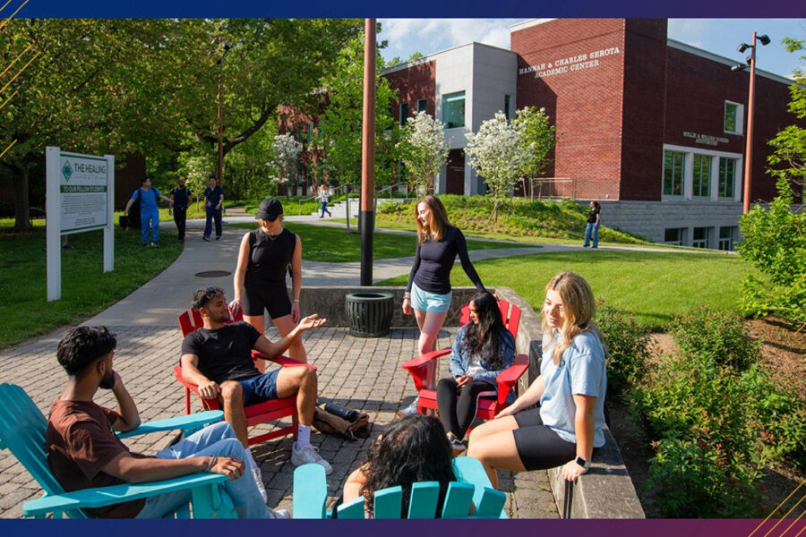 Group of students sitting in lawn chairs on quad.