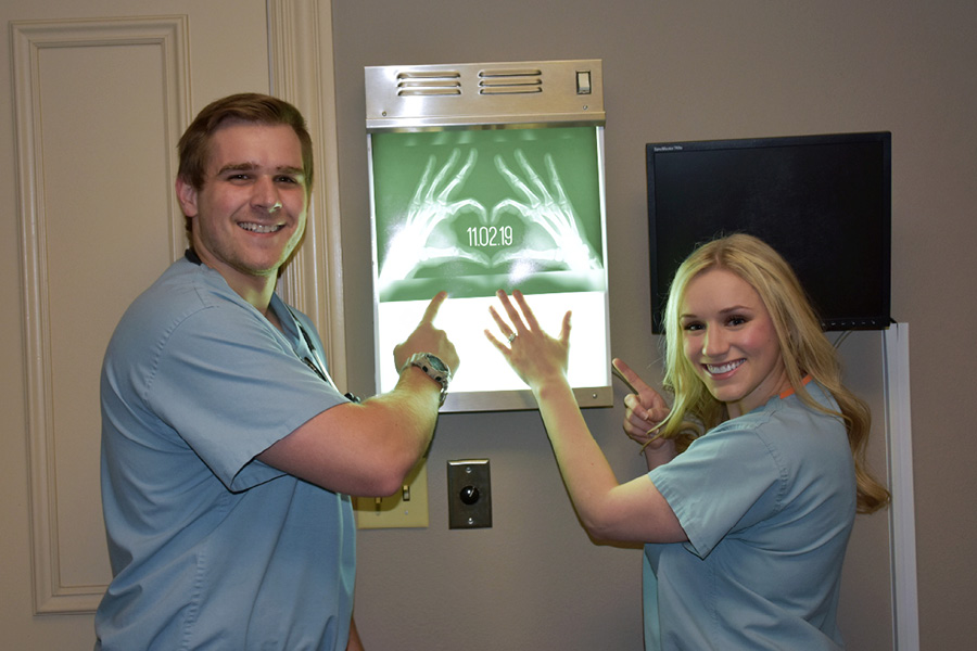 Nathan and Shelby Tripod on front of an x-ray viewing box showing two hands forming a heart