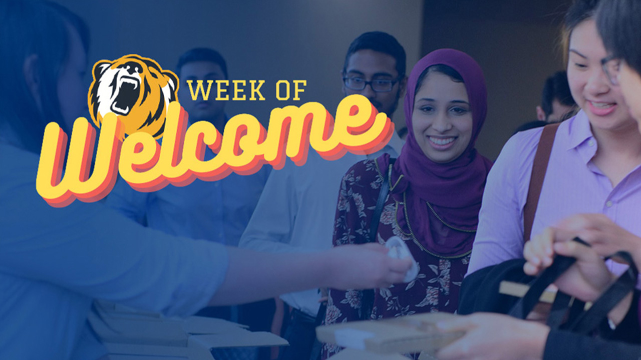 Group of students grabbing lunch packs with Week of Welcome Logo