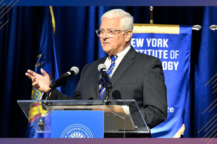 NYIT president speaking at a podium.