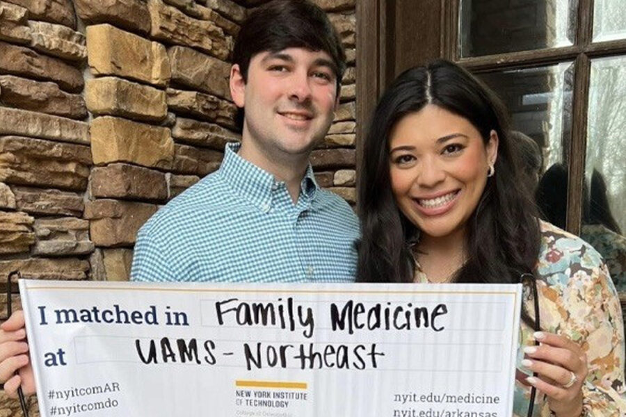 Two students holding their match sign.