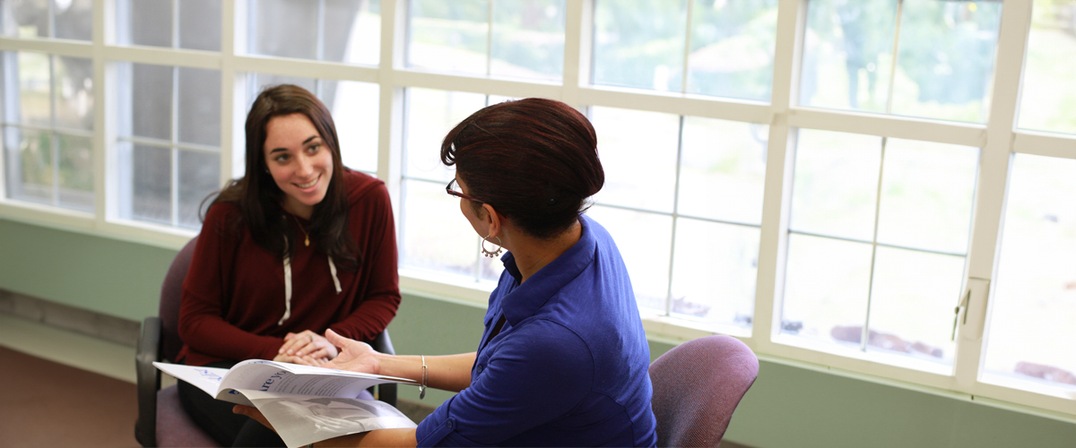 Students are studying together in front of a large window.