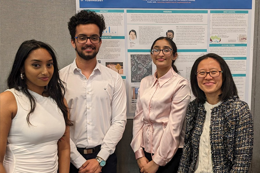 Group of students in front of a project board.